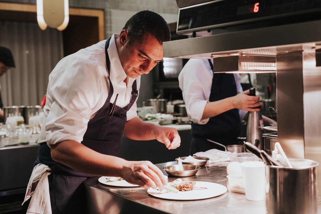 Chef Julien Royer prepares a dish at Odette. Photo: Odette Chef Julien Royer prepares a dish at Odette. Photo: Odette