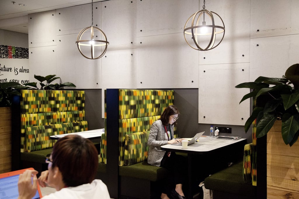 Employees work on laptops in a common area at Google’s Asia-Pacific headquarters in Singapore. Tech giants such as Google are asking workers to be in the office three days a week. Photo: Bloomberg