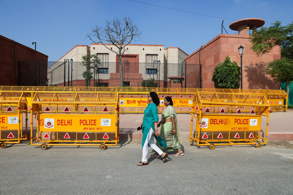 Women walk past India’s new parliament in New Delhi. Women make up almost half of India’s 950 million registered voters. Photo: Reuters