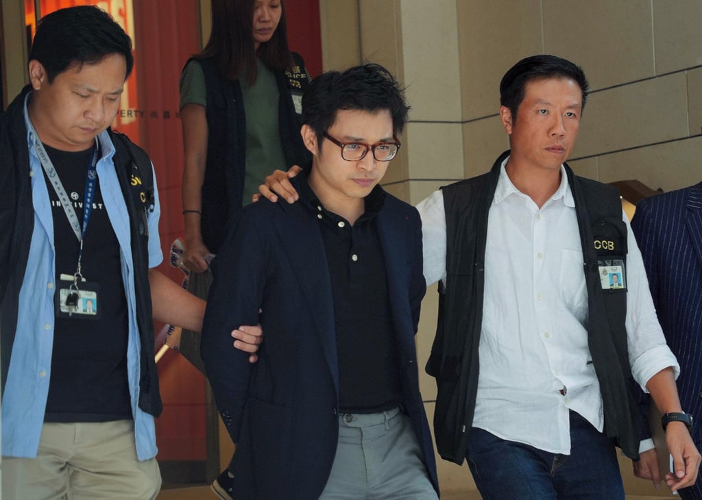 Police officers escort influencer Joseph Lam Chok (middle) from the Entertainment Building in Central. Photo: Handout Police officers escort influencer Joseph Lam Chok (middle) from the Entertainment Building in Central. Photo: Handout
