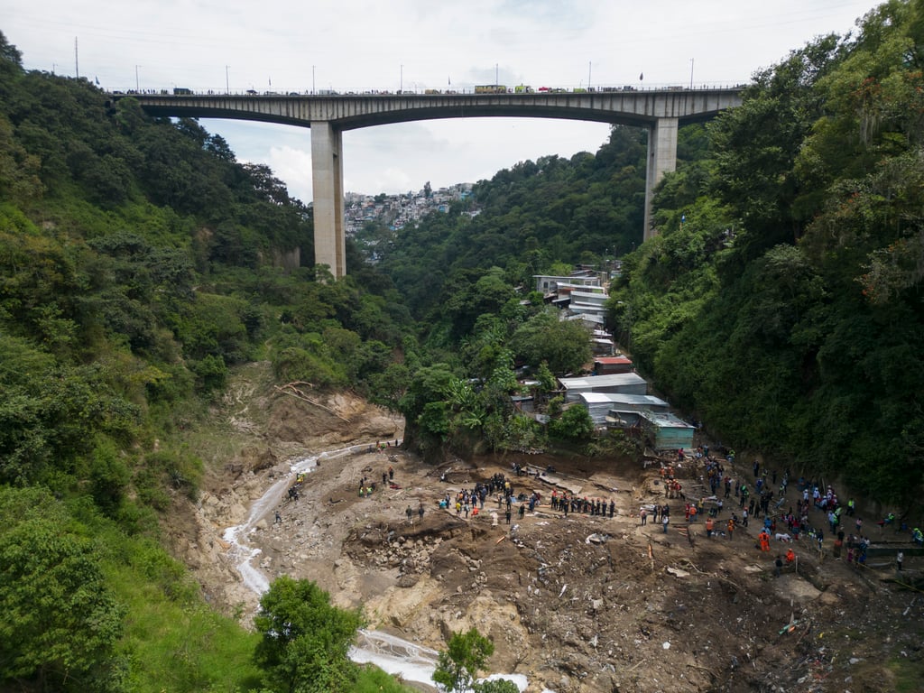 The Naranjo River moves through the Dios es fiel, or “God is Loyal” shanty on the outskirts of Guatemala City on Monday. Photo: AP