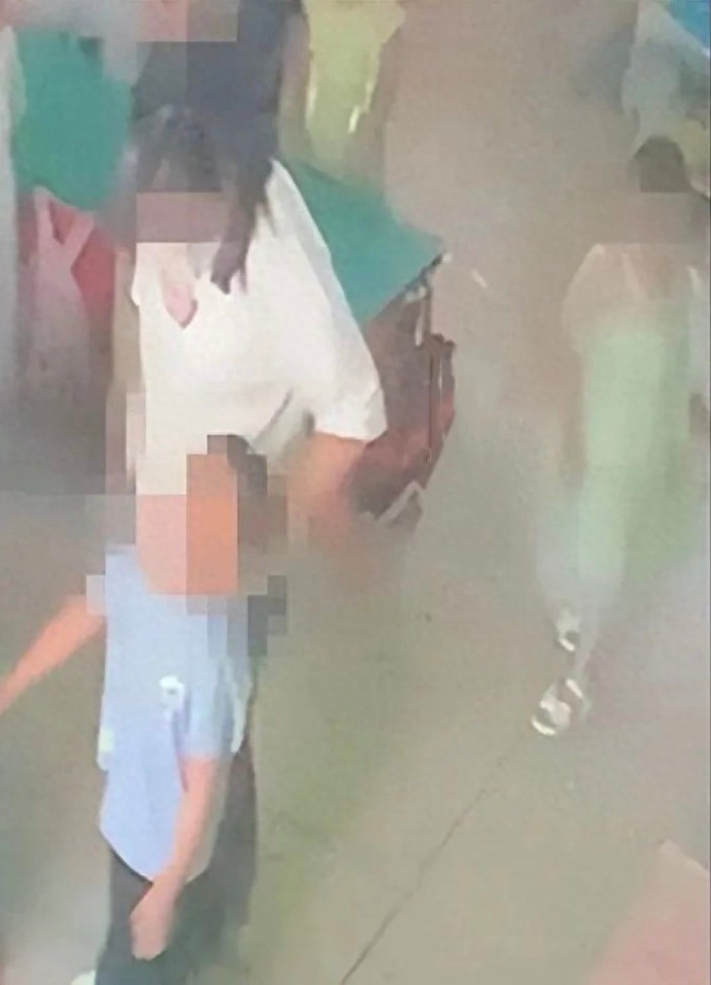 Surveillance footage from the kindergarten shows a teacher yanking a child by his hair from behind. Photo: Douyin