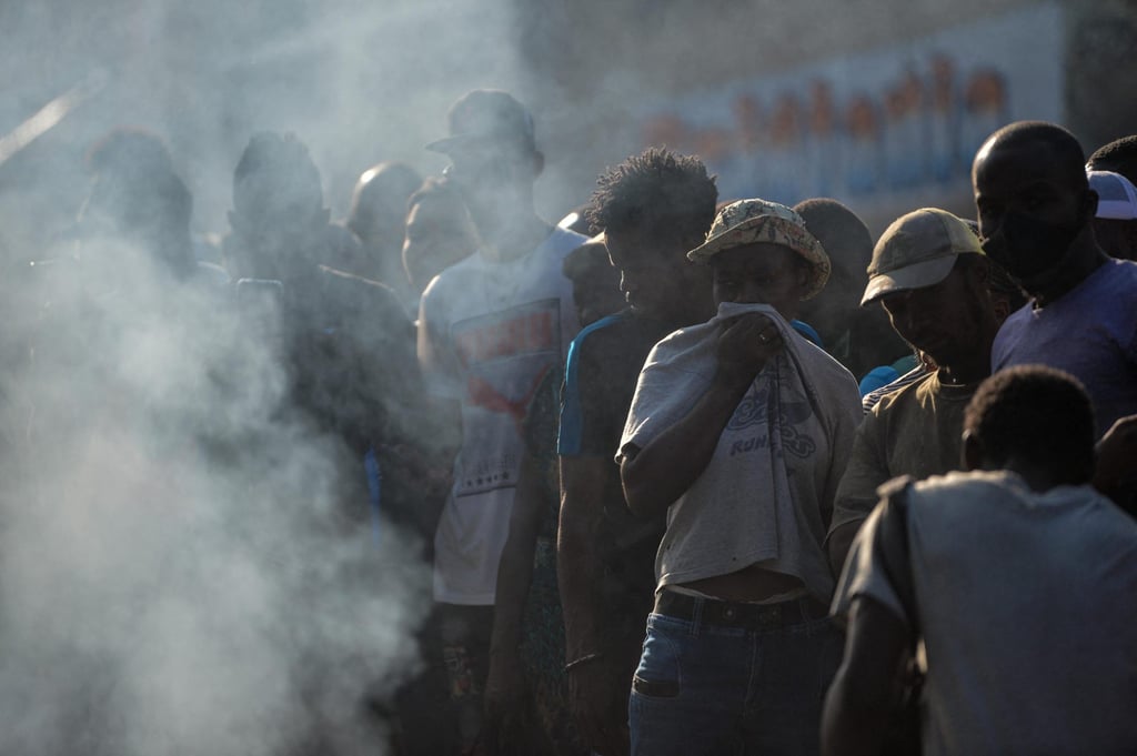 People look at the bodies of suspected gang members being burned in a street in Port-au-Prince. File photo: AFP
