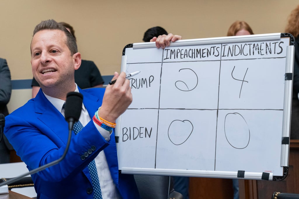 US Democratic congressman Jared Moskowitz holds up a whiteboard comparing the impeachments and indictments of former president Donald Trump and President Joe Biden on Capitol Hill on Thursday. Photo: AP US Democratic congressman Jared Moskowitz holds up a whiteboard comparing the impeachments and indictments of former president Donald Trump and President Joe Biden on Capitol Hill on Thursday. Photo: AP