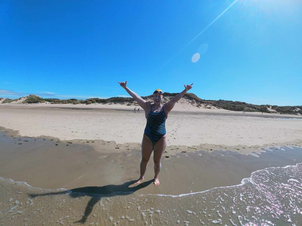 Edie Hu celebrates on a French beach after swimming across the English Channel. Photo: Jenny Barbour Edie Hu celebrates on a French beach after swimming across the English Channel. Photo: Jenny Barbour