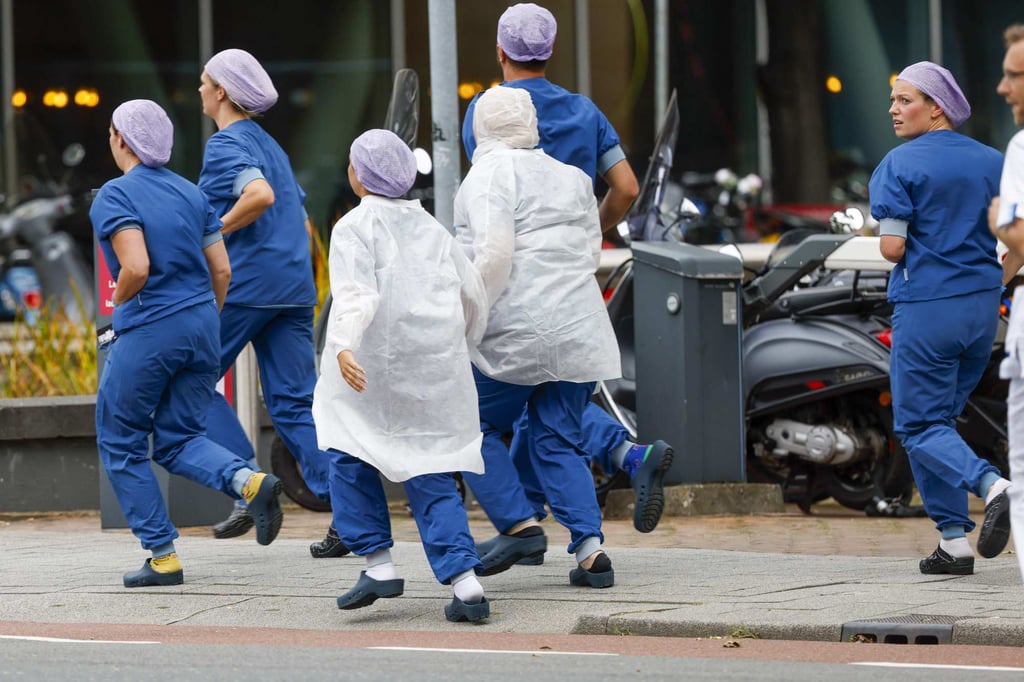 Medical staff running out of the hospital. Photo: AFP Medical staff running out of the hospital. Photo: AFP