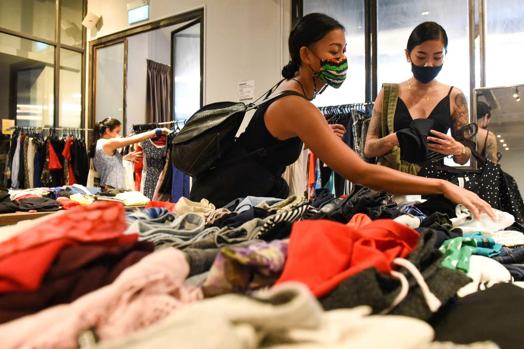 Shoppers browse second-hand clothes in Singapore. Photo: AFP Shoppers browse second-hand clothes in Singapore. Photo: AFP