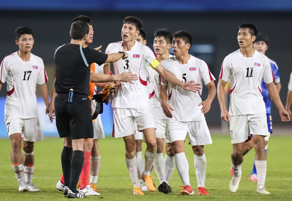 Captain Jang Kuk-chol led his out-of-control teammates in rounding on Uzbek official Lutfullin Photo: Kyodo.