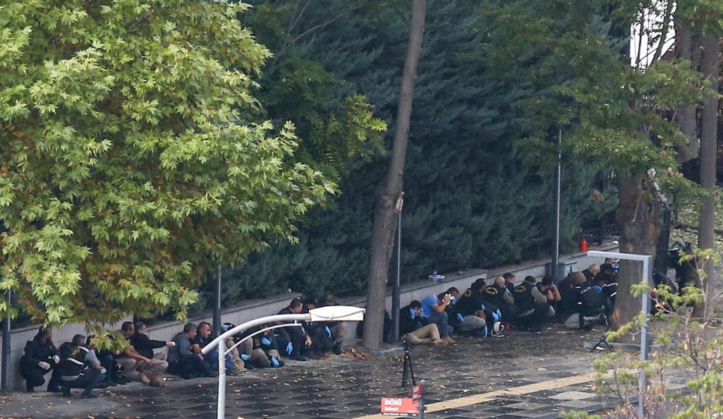 Turkish Police take cover as an unexploded bomb is detonated in front of the Interior Ministry following a bomb attack in Ankara. Photo: Reuters