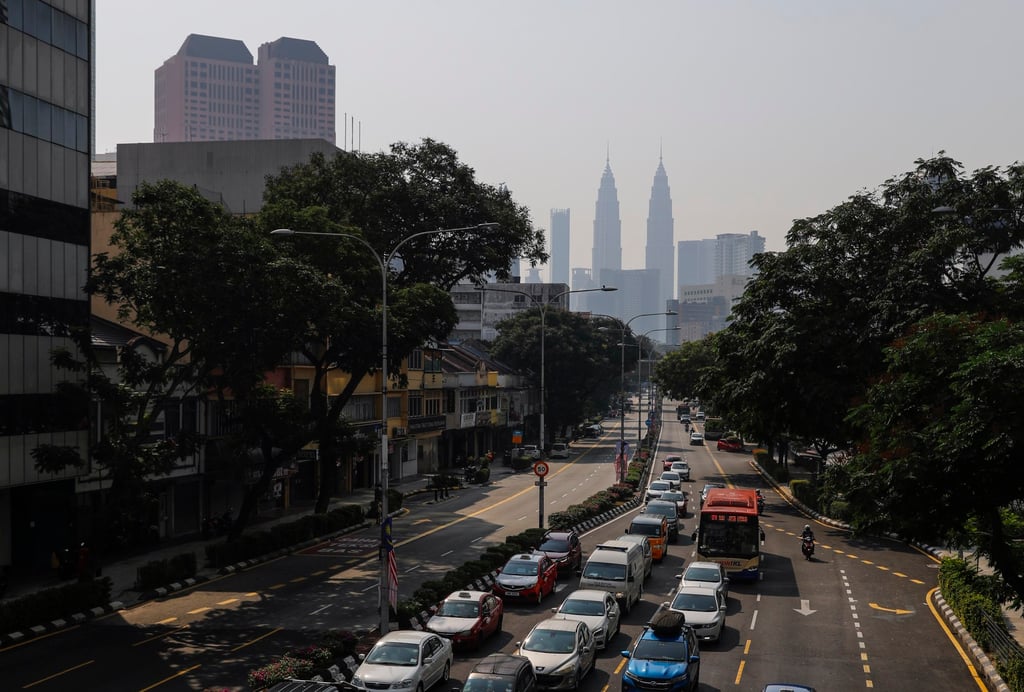 Cars wait in traffic near the Petronas Twin Towers which are clouded in haze in Kuala Lumpur, Malaysia, on Friday. Photo: EPA-EFE