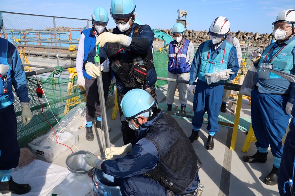 Tokyo Electric Power Company staff members sampling water from the upper-stream storage, two days before the second discharge of treated radioactive water at the Fukushima nuclear power plant. Photo: EPA-EFE