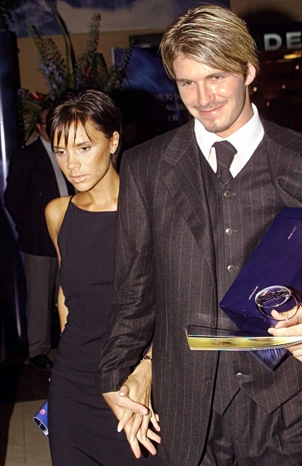 David Beckham holds hands with his wife Victoria as they leave the UEFA Awards Ceremony in Monaco, in 1999. Photo: AP