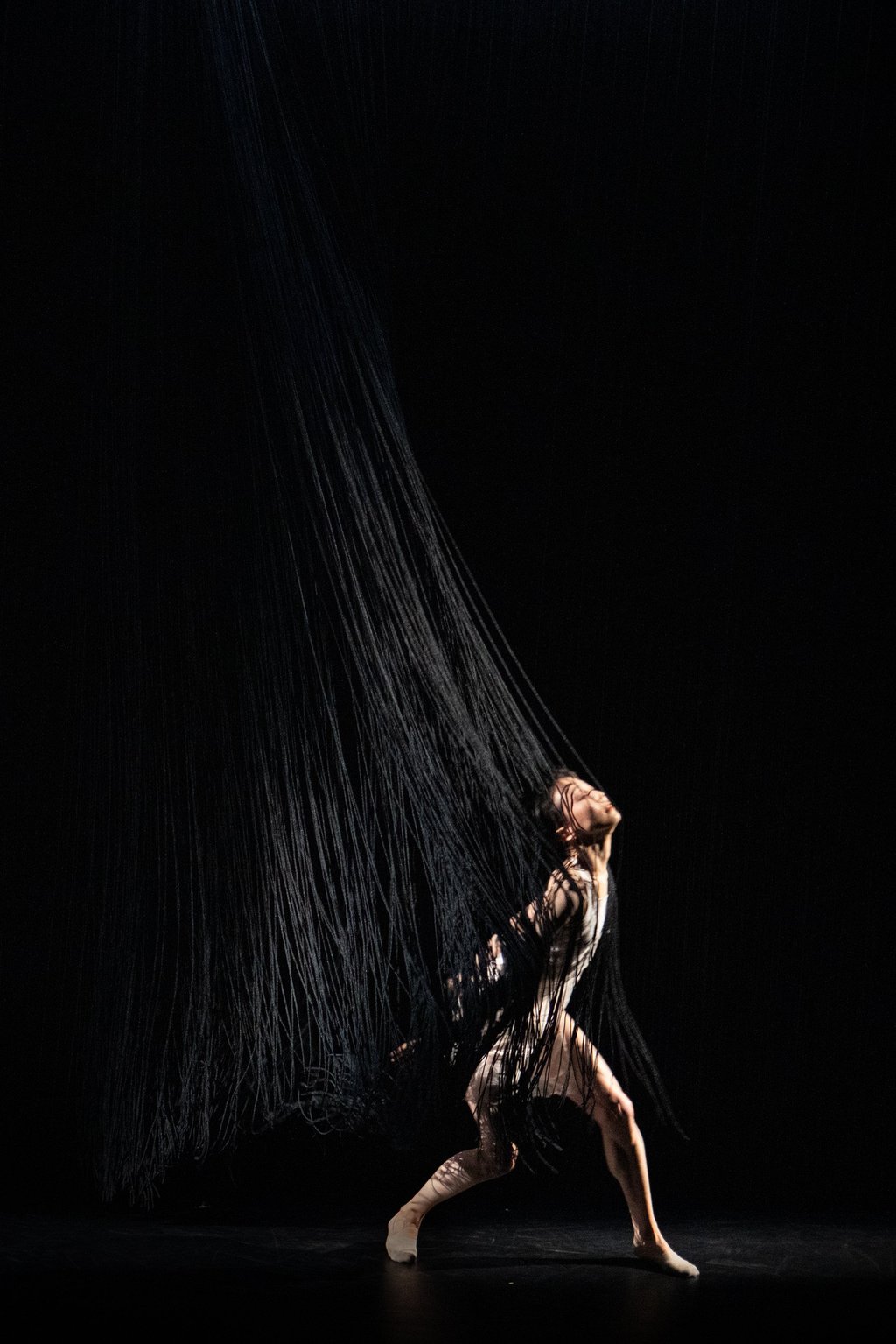 The set design for Rain adapted an installation artwork by Shinji Ohmaki, titled Liminal Air – Black Weight, that consists of a giant black rectangle made of hanging nylon strings.