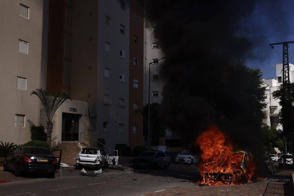 Burning cars following a rocket attack in Israel. Photo: Bloomberg Burning cars following a rocket attack in Israel. Photo: Bloomberg