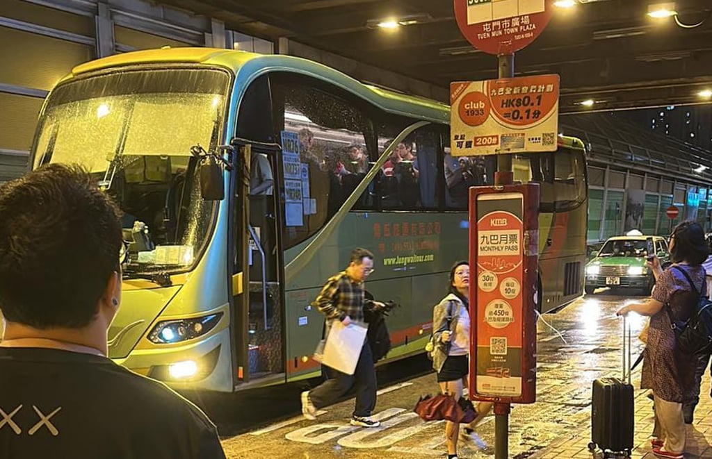 Big-hearted volunteer drivers from a private coach company help passengers stranded at Tsuen Wan West MTR station in a typhoon No 9 alert. Photo: JoJo Bus