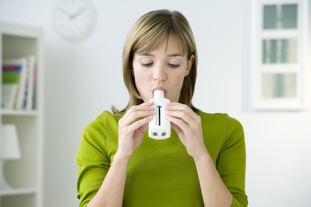 A woman exhales into a device. Wadhwa has been working on a project to detect cancer in people using only their breath – similar to using a breathalyser. Photo: Shutterstock