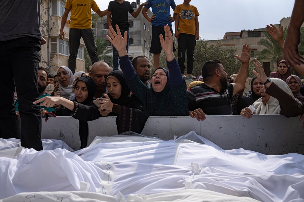Relatives mourn people killed in an Israeli air strike in Gaza City on Monday. Photo: AP