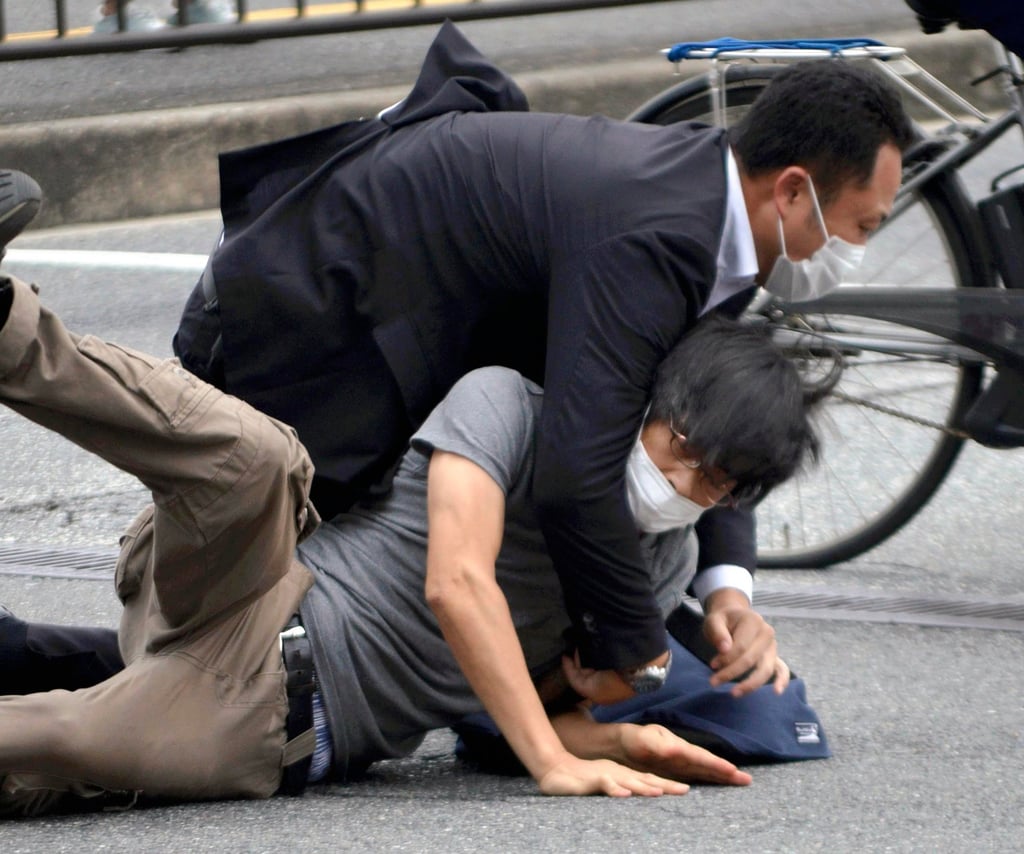 Tetsuya Yamagami is detained near the site of Abe’s assassination in Nara prefecture, in western Japan, on July 8, 2022. Photo: AP
