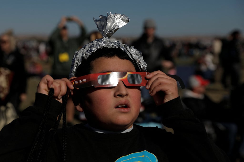 Ten-year-old Ezra Martinez watches the annular solar eclipse at the Albuquerque International Balloon Fiesta in Albuquerque, New Mexico, on Saturday. Photo: Reuters Ten-year-old Ezra Martinez watches the annular solar eclipse at the Albuquerque International Balloon Fiesta in Albuquerque, New Mexico, on Saturday. Photo: Reuters