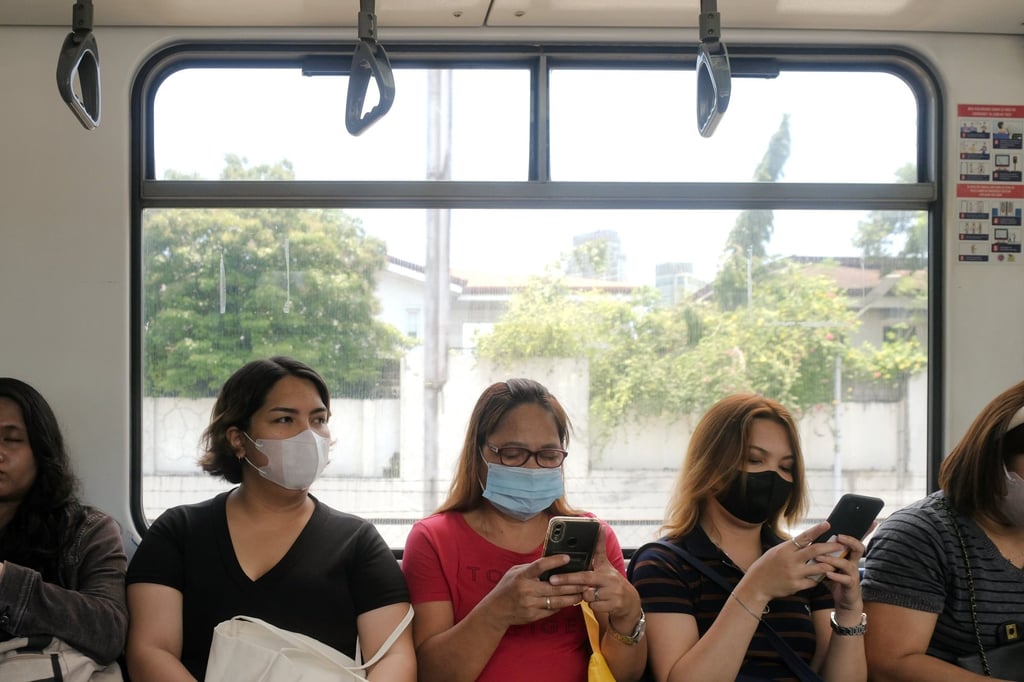 People use their phones on a train in Manila. The breach into PhilHealth servers affected both domestic residents and overseas Filipino workers. Photo: Shutterstock People use their phones on a train in Manila. The breach into PhilHealth servers affected both domestic residents and overseas Filipino workers. Photo: Shutterstock