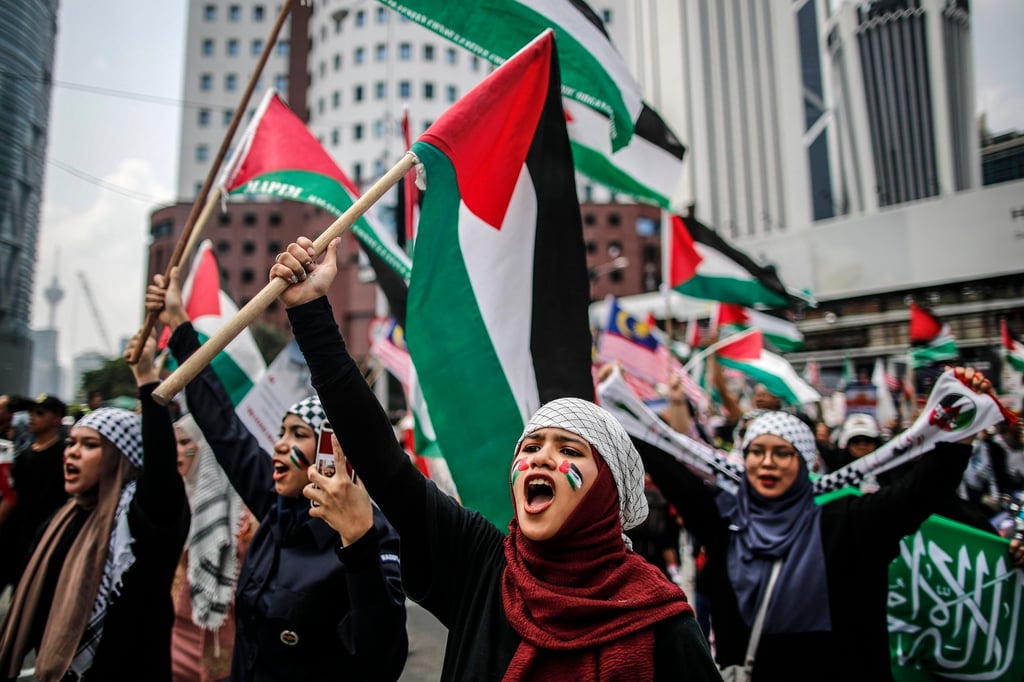 Women hold Palestinian flags while marching to the US embassy on October 13. Malaysia has long supported the Palestinian cause and hosted Hamas leaders. Photo: EPA-EFE Women hold Palestinian flags while marching to the US embassy on October 13. Malaysia has long supported the Palestinian cause and hosted Hamas leaders. Photo: EPA-EFE