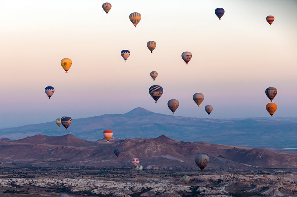Hot air balloons flying over Cappadocia. For US$159, Uber will reserve visitors a spot on a sunrise flight over the volcanic region in central Turkey. Photo: Xinhua Hot air balloons flying over Cappadocia. For US$159, Uber will reserve visitors a spot on a sunrise flight over the volcanic region in central Turkey. Photo: Xinhua