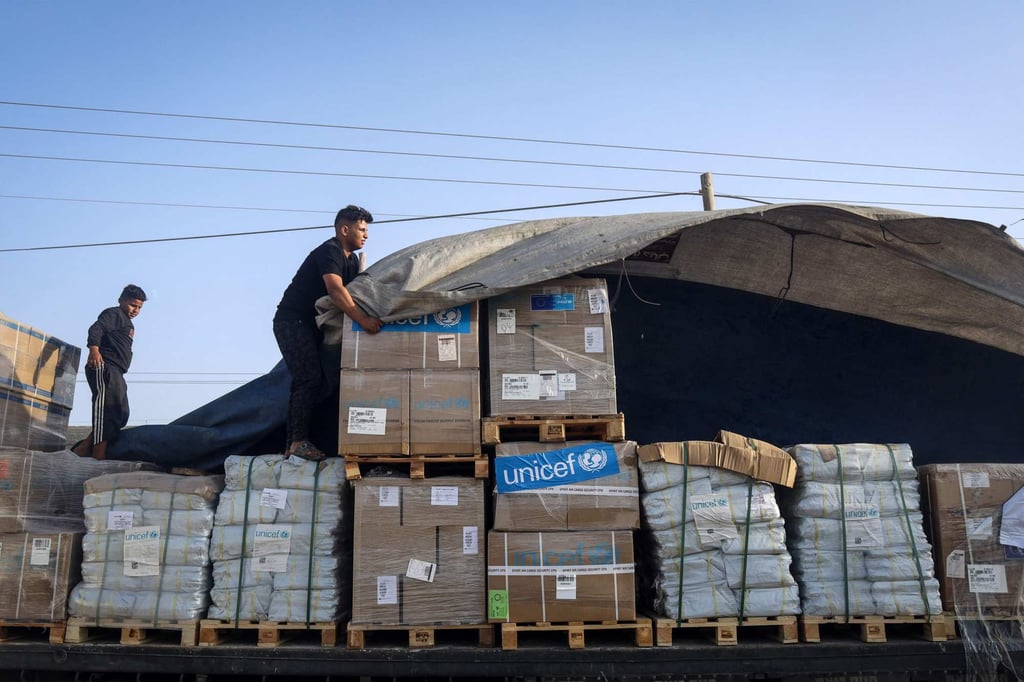 A man unloads humanitarian aid in Gaza on Saturday. Photo: AFP