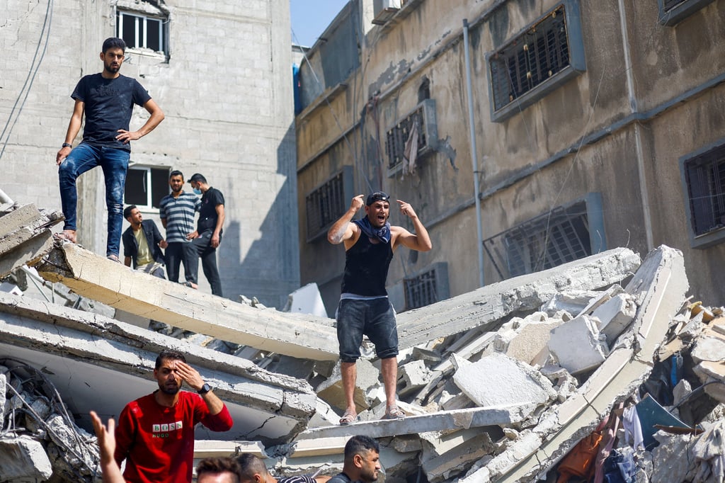 A man reacts as Palestinians gather to search for casualties at the site of an Israeli strike on a house in the southern Gaza Strip on Tuesday. Photo: Reuters