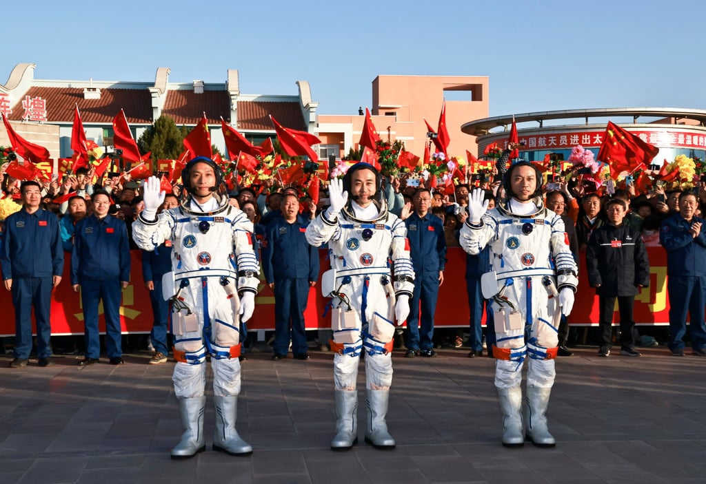 Chinese astronauts Tang Hongbo (right), Tang Shengjie (centre) and Jiang Xinlin are seen off at the launch centre on Thursday. The Long March 2F rocket carrying their ship took off at 11.14am. Photo: Xinhua