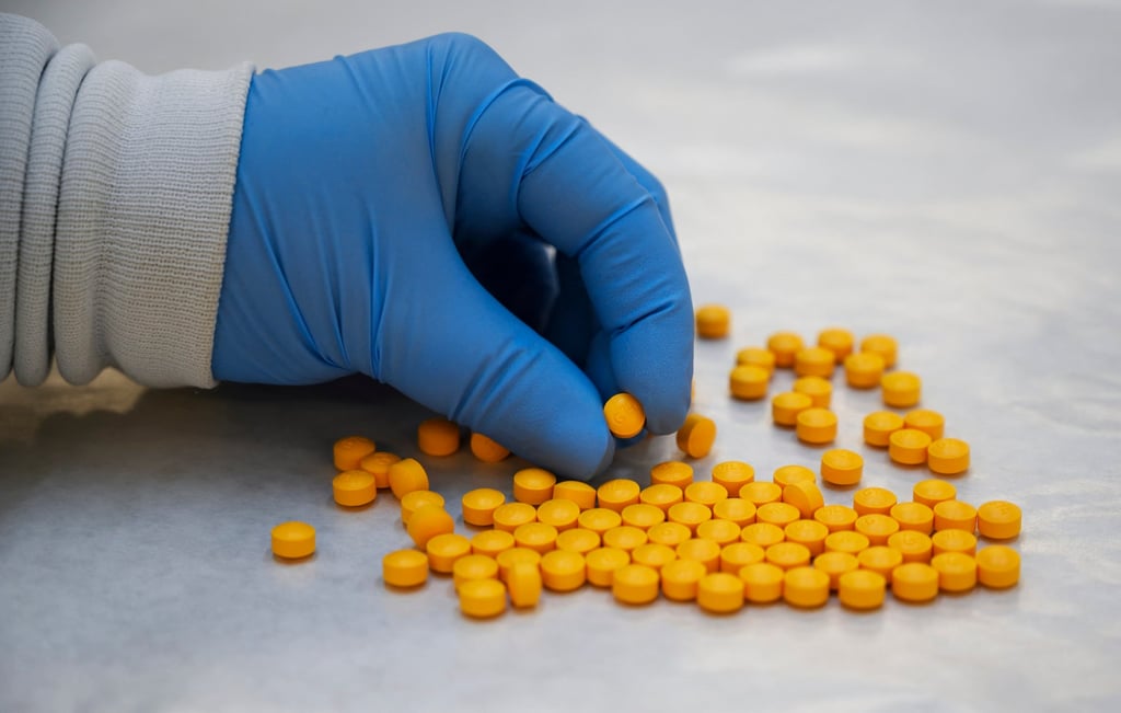AA US Drug Enforcement Administration chemist checks confiscated fentanyl pills. Photo: AFP