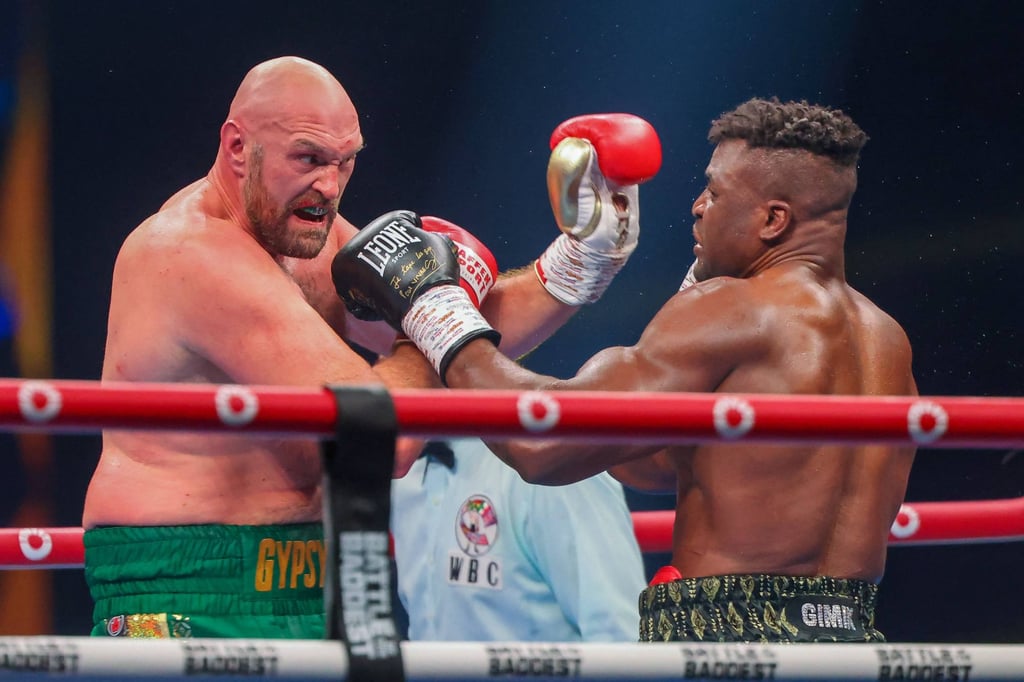 Tyson Fury and Francis Ngannou exchange punches. Photo: AFP Tyson Fury and Francis Ngannou exchange punches. Photo: AFP