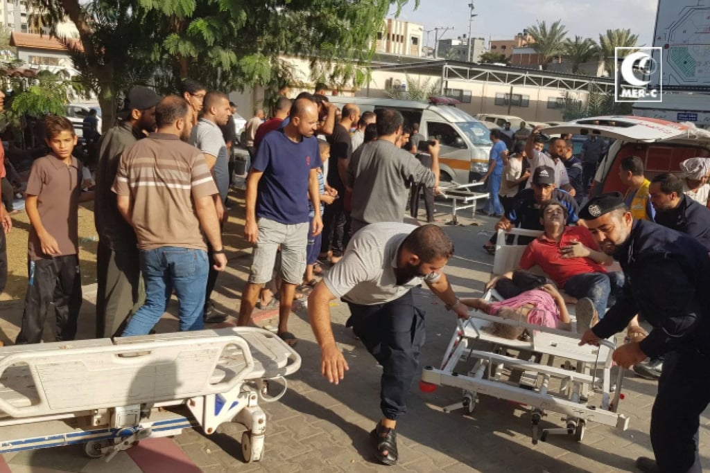 Workers from the Medical Emergency Rescue Committee (Mer-C) attend to victims of an Israeli attack. Photo: Handout/Mer-C