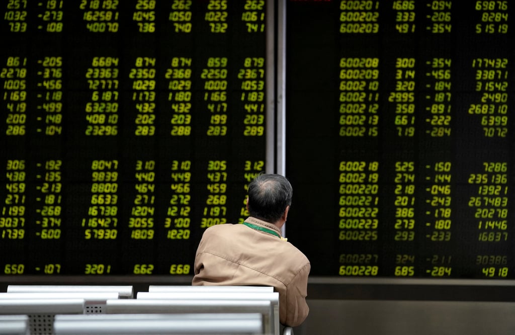 An investor watches a board showing stock information at a brokerage office in Beijing, China October 8, 2018. Photo: Reuters