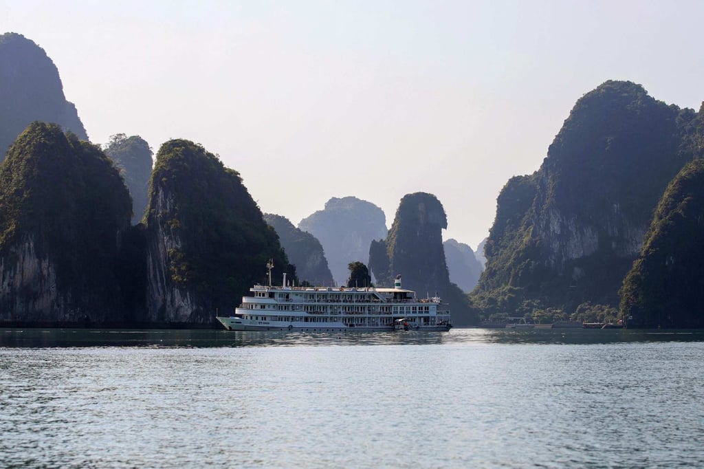 A tourist boat next to karst formations in Ha Long Bay. Photo: AFP