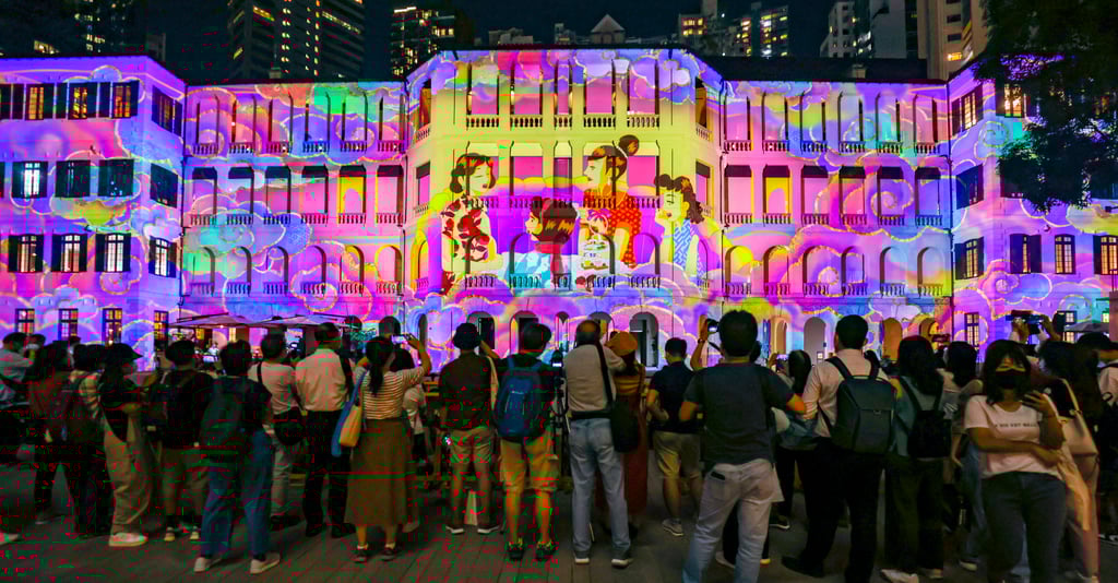 A crowd of people watch InnerGlow, a dynamic light show featuring digital art projections in the old Parade Ground at Hong Kong’s historic Tai Kwun, in Central. Photo: SCMP/K.Y. Cheng A crowd of people watch InnerGlow, a dynamic light show featuring digital art projections in the old Parade Ground at Hong Kong’s historic Tai Kwun, in Central. Photo: SCMP/K.Y. Cheng