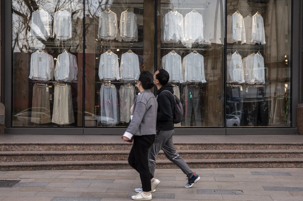Pedestrians pass a Muji store, operated by Ryohin Keikaku, in Shanghai on March 26, 2021. Photo: Bloomberg