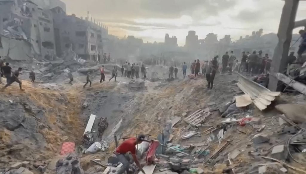 Palestinians look for survivors in a crater made by an Israeli strike on a refugee camp in the northern Gaza Strip on October 31 in this still from video footage. Photo: AFP Palestinians look for survivors in a crater made by an Israeli strike on a refugee camp in the northern Gaza Strip on October 31 in this still from video footage. Photo: AFP