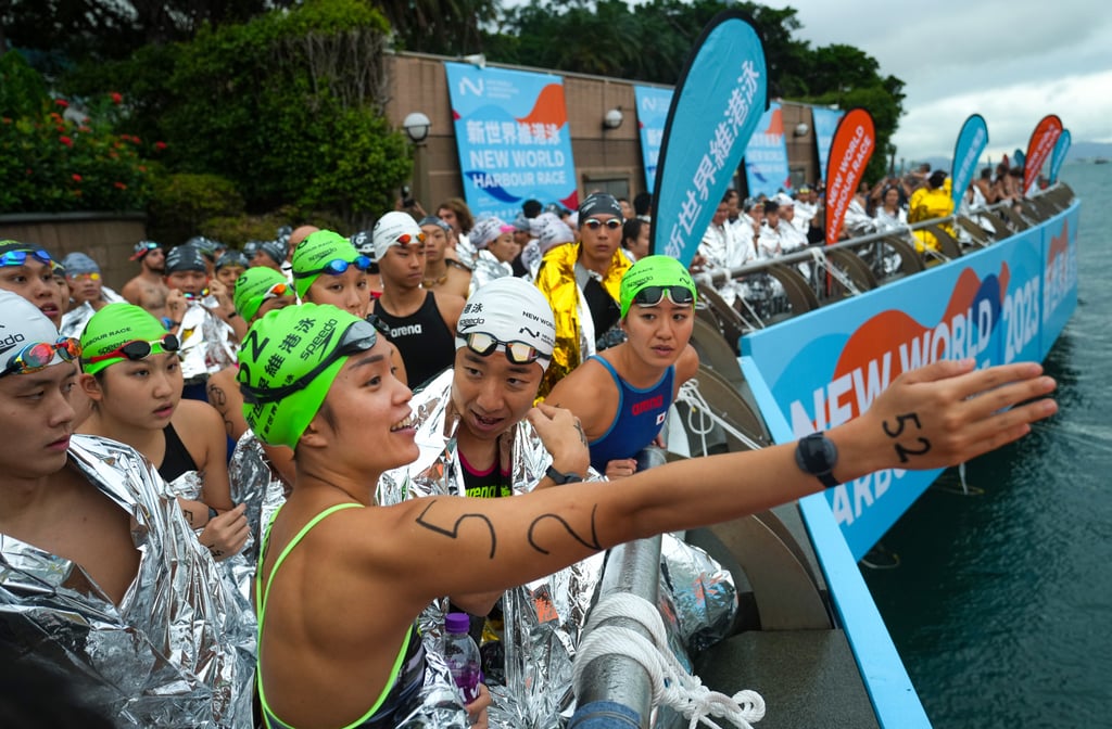 Swimmers assemble beside Golden Bauhinia Square for the early morning race. Photo: Sam Tsang