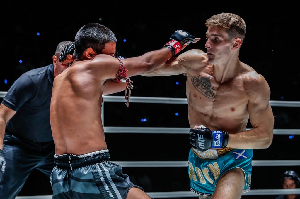 Nico Carillo lands a punch on Muangthai. Nico Carillo lands a punch on Muangthai.
