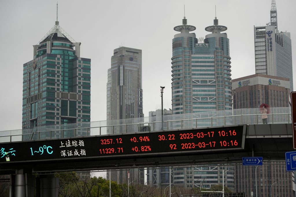 An electronic board shows Shanghai and Shenzhen stock indices at the Lujiazui financial district in Shanghai on March 17, 2023. Photo: Reuters