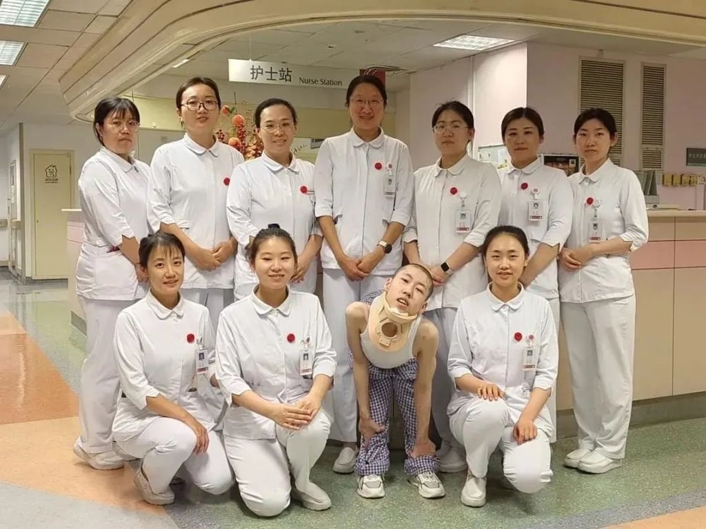 Jiang is pictured with the dedicated medical staff who are with him on his painstaking journey. Photo: Peking University Jiang is pictured with the dedicated medical staff who are with him on his painstaking journey. Photo: Peking University