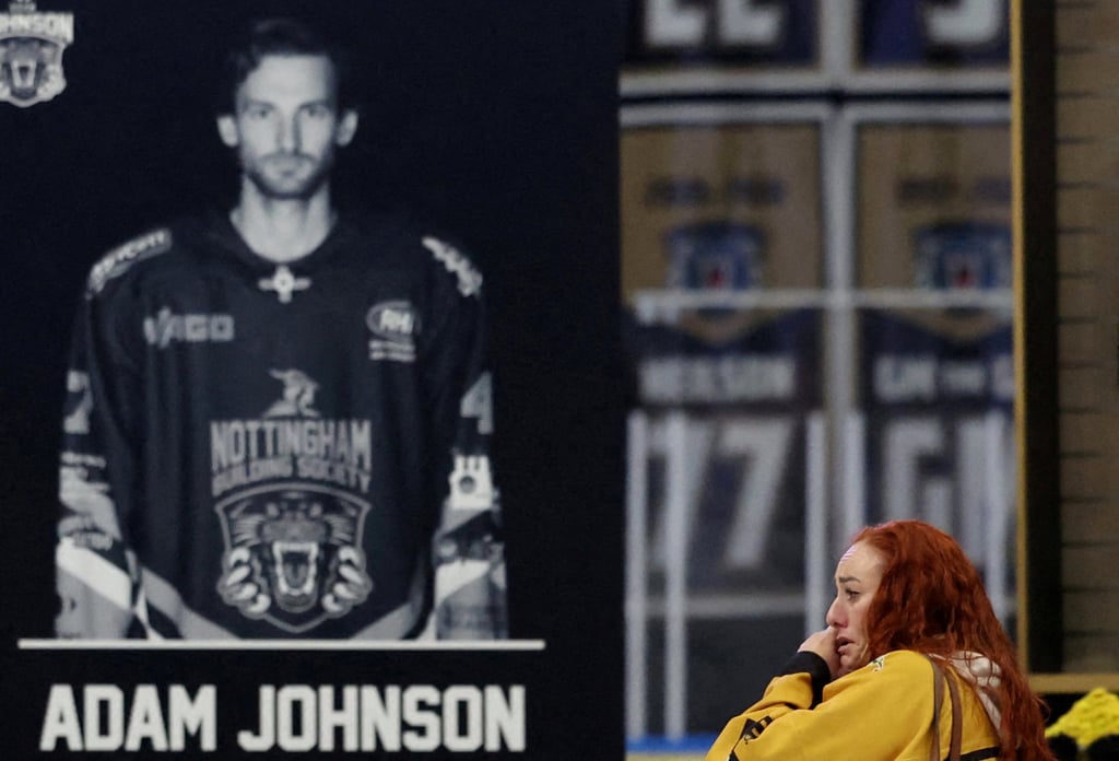 A woman cries in Motorpoint Arena, Nottingham, on November 4 during the memorial for Nottingham Panthers’ Adam Johnson. Photo: Reuters