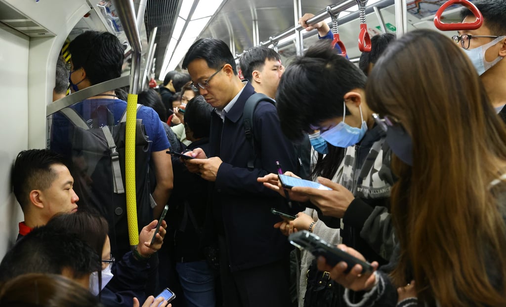 These MTR commuters are glued to their mobile phones and, like other modern-day Hongkongers, could not bear to be deprived of their use for even a few hours. Photo: Dickson lee