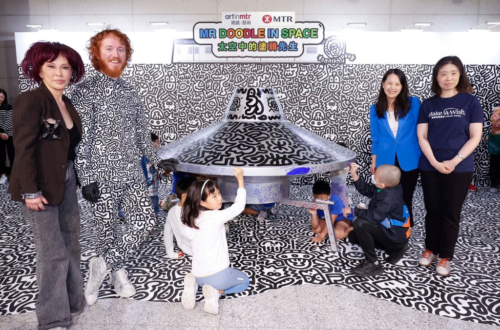 Gallerist Pearl Lam (left) and the artist Sam Cox a.k.a. Mr Doodle after the artist gave a live art performance at the Hong Kong MTR station. Photo: MTR Gallerist Pearl Lam (left) and the artist Sam Cox a.k.a. Mr Doodle after the artist gave a live art performance at the Hong Kong MTR station. Photo: MTR