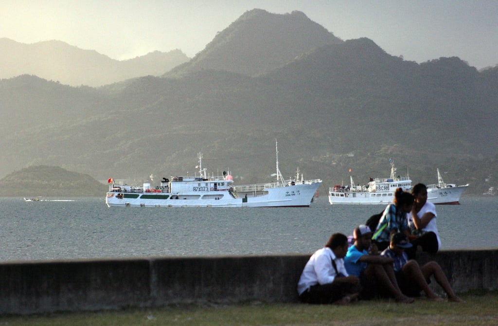 Locals sit on a wall on the foreshore of the harbour in Fiji’s capital, Suva, in 2014. The Australian government has already funded a feasibility study to explore redevelopment of Fiji’s port facilities. Photo: Reuters