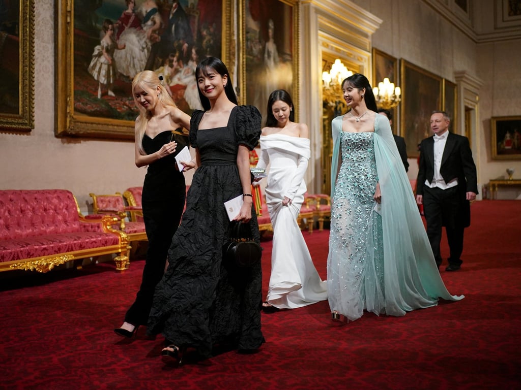 Resplendent in black, white and aquamarine, the four members of Blackpink arrive at Buckingham Palace to attend a state banquet during the visit of South Korean President Yoon Suk-yeol, in London, Britain, on November 21. Photo: Reuters Resplendent in black, white and aquamarine, the four members of Blackpink arrive at Buckingham Palace to attend a state banquet during the visit of South Korean President Yoon Suk-yeol, in London, Britain, on November 21. Photo: Reuters