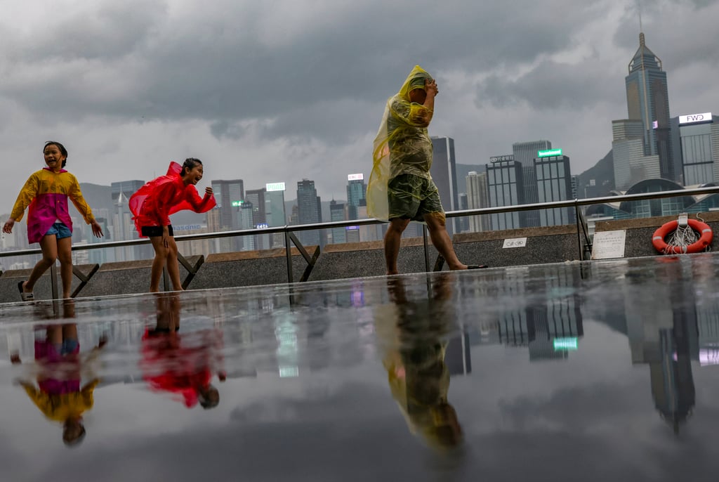 Visitors walk along the Tsim Sha Tsui waterfront as Super Typhoon Saola hits on September 1. Photo: Yik Yeung-man Visitors walk along the Tsim Sha Tsui waterfront as Super Typhoon Saola hits on September 1. Photo: Yik Yeung-man