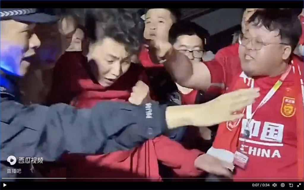 A fan who had been wearing a Son Heung-min jersey is escorted away by police as angry Chinese supporters surrounded him outside the stadium in Shenzhen. Photo: Weibo