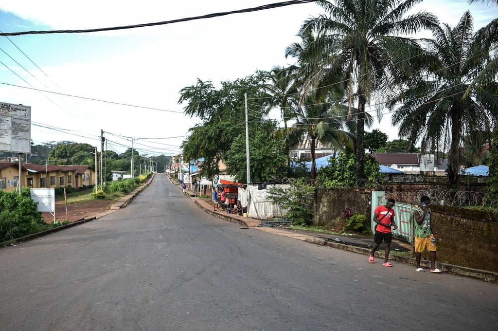Two men walk along an empty road in Freetown. Photo: AFP Two men walk along an empty road in Freetown. Photo: AFP