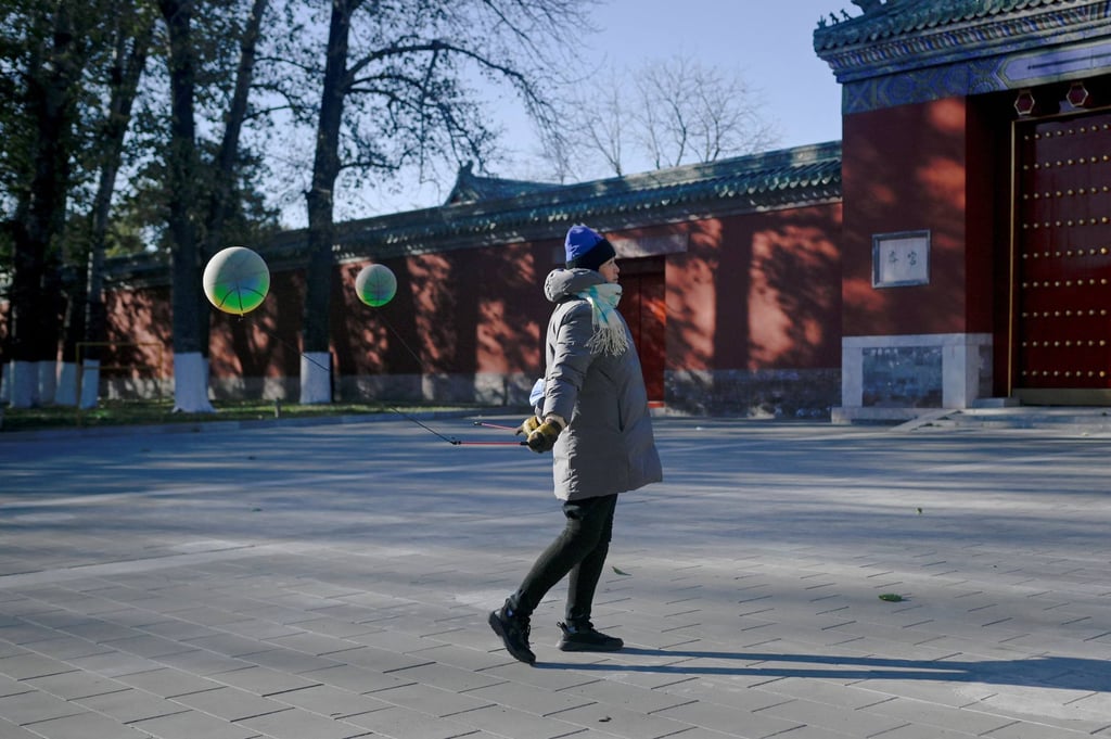 A woman uses balls to exercise at a park in Beijing on November 30, 2023. Photo: AFP A woman uses balls to exercise at a park in Beijing on November 30, 2023. Photo: AFP